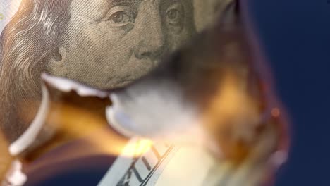 Fire-burning-up-100-US-Dollar-bill,-economy-collapse-concept