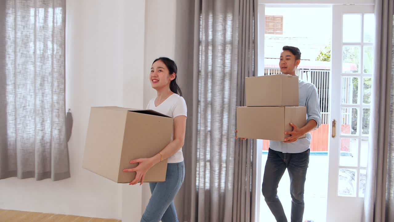 Couple Carrying Moving Boxes