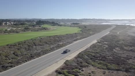 vehicle aerial view following along california state route 1 driving road trip travel vacation