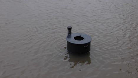 trash can immerse in the flood water on the street