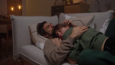 couple sleeping on a couch