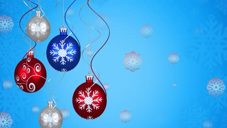animación de bolas de navidad sobre copos de nieve sobre fondo azul