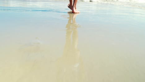 Man-walking-on-the-beach