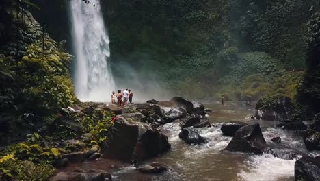 bali, spring 2020 in 1080 60p, daytime, cinematic drone flight a high slow motion horizontally from left to right flight in front of a waterfall clos over the river