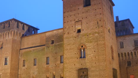 exterior view of castello di san giorgio at night in mantua, italy. - tilt down shot