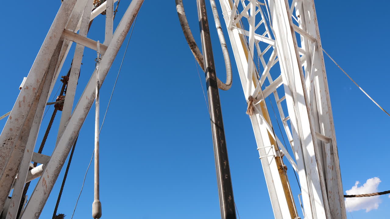 Footage at the rig for drilling gas or oil. Equipment at work attached to metal supports at the site for production of metal resources.
