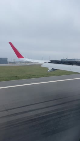 Airplane Wing View at Airport