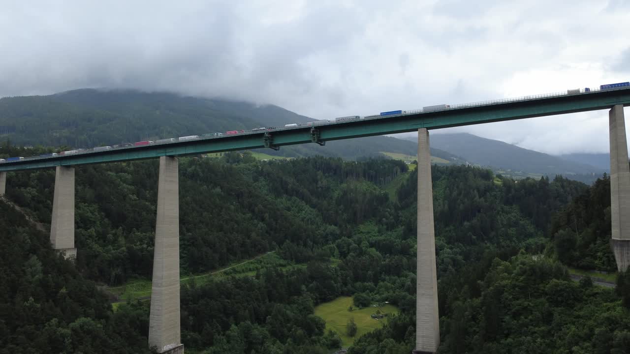 Dramatic drone clip flying beneath the iconic Brenner Bridge in Tyrol. A rare angle showcasing engineering and mountain surroundings