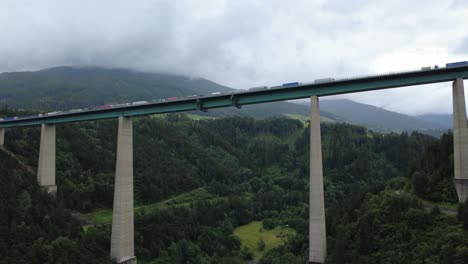 dramatic drone clip flying beneath the iconic brenner bridge in tyrol. a rare angle showcasing engineering and mountain surroundings