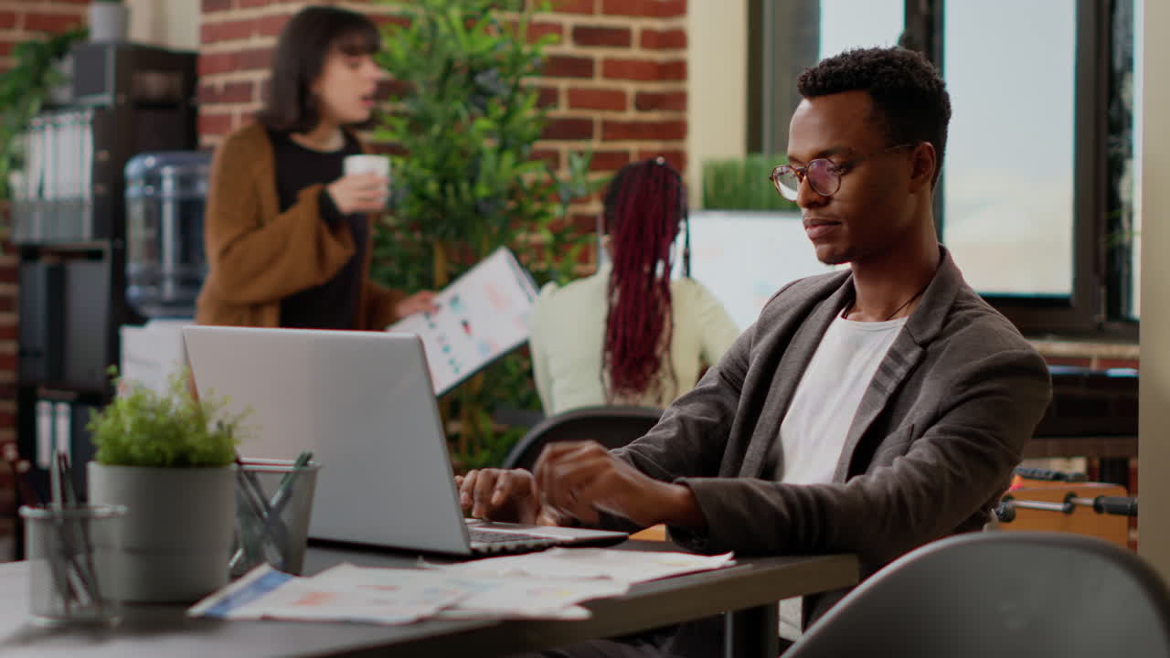 African american man analyzing business data research on laptop