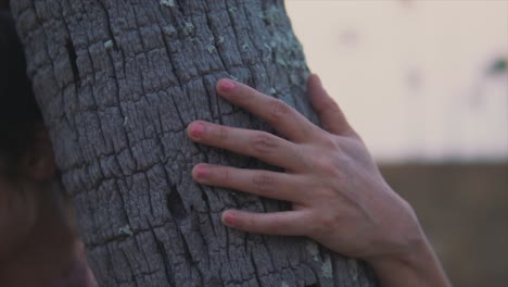 close-up of young woman hand resting at on a tree