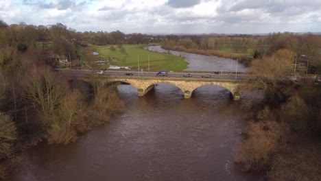 cinematic pan upwards to carlisle's eden bridge over river eden with rickerby park