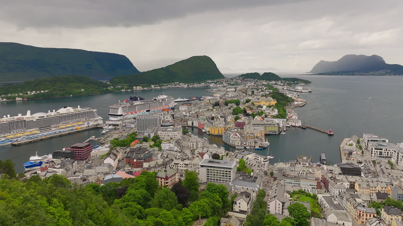 Vehicles travelling through the port town of &Aring;lesund while ships are moored