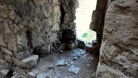 A-view-from-inside-the-Genoese-Fortress-in-Feodosia,-Russia,-showing-the-stone-walls-and-a-glimpse-of-the-surrounding-landscape