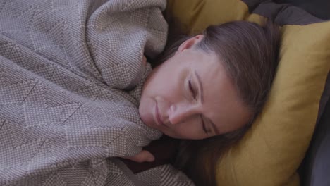 Woman-sleeping-on-the-couch-at-home