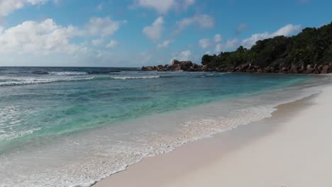 aerial view of the white beaches and turquoise waters at anse coco, petit anse and grand anse on la digue, an island of the seychelles