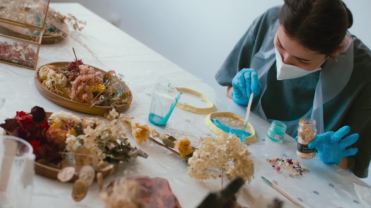 Woman Making Resin Crafts with Dried Flowers