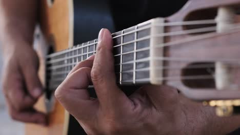 playing guitar, unique view following from the strumming hand to fretting hand and back again