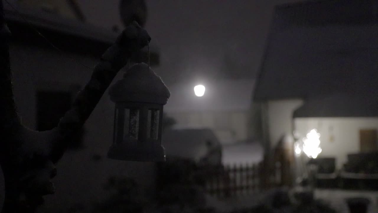 little lantern blowing in a snow storm at night