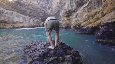 adventurous young man in sea cave.