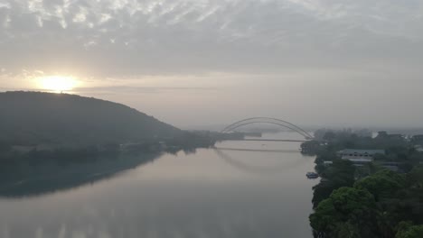 drone shot jibbing up to see adomi bridge on horizon at akosombo atimpoku, eastern region