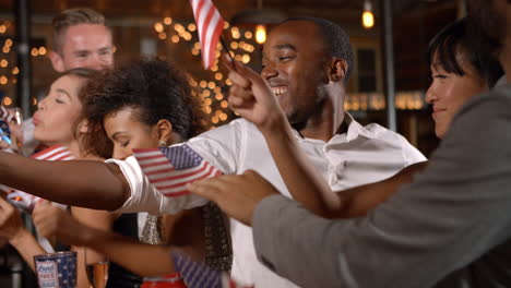 friends celebrating july 4th at a party in a bar