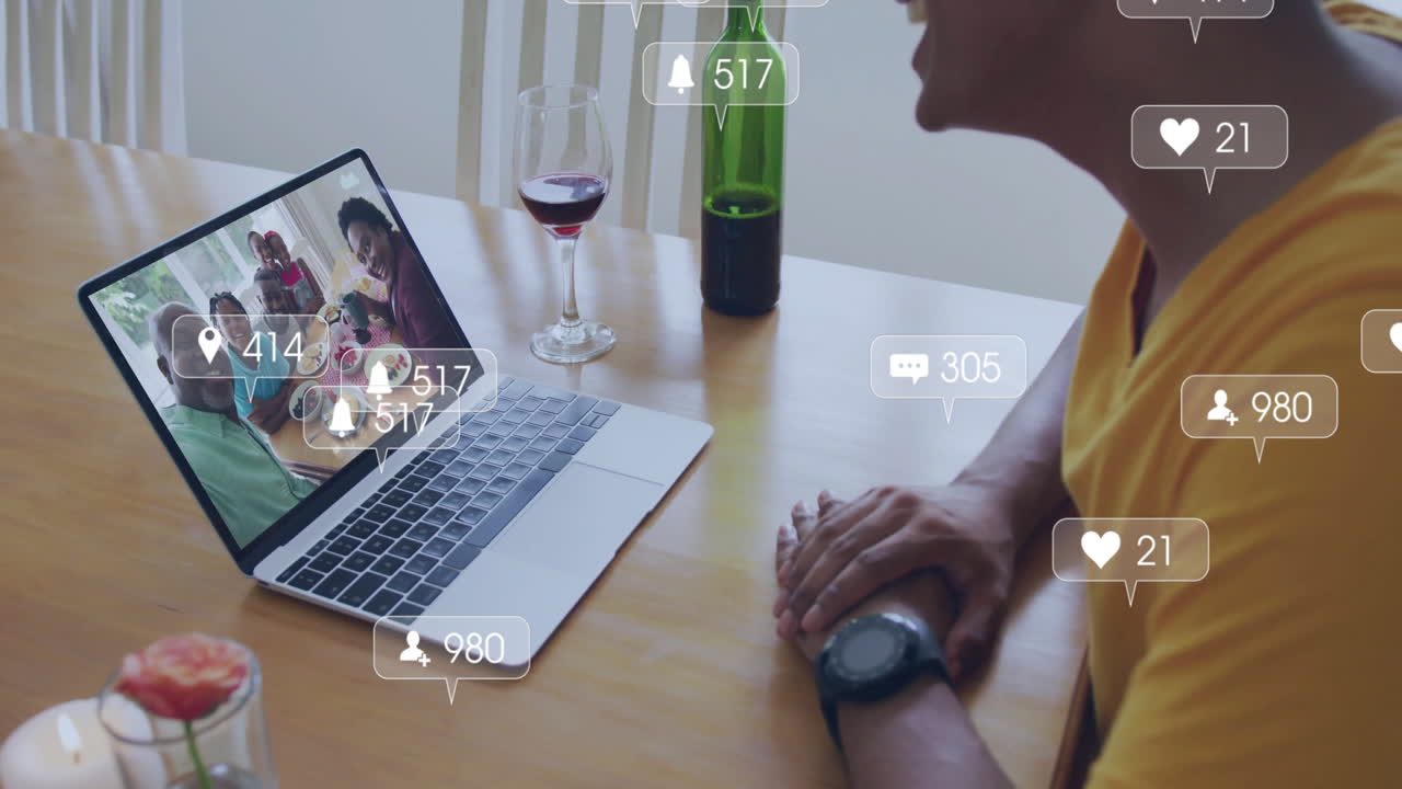 Social media notifications animation over person video chatting on laptop with wine