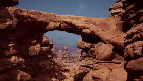 a natural rock arch in a desert canyon