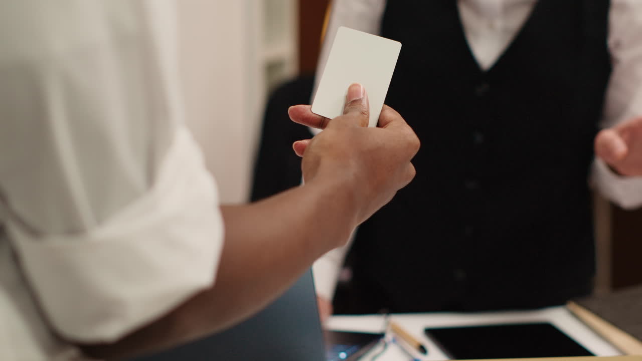 Receptionist handing room card key