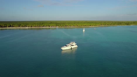 aerial view approaching a yacht on the coast of punta cana, sunset in dominican republic