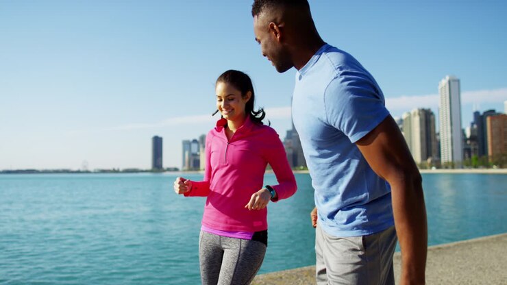 Multi Ethnic people running and stretching by shoreline