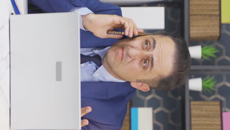 Vertical-video-of-Stressed-talking-businessman-on-the-phone.