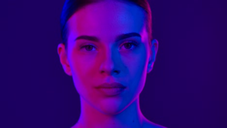 portrait of a woman with vibrant neon lighting effects a woman holding a makeup brush illuminated by vibrant purple and blue neon lighting creating a modern and artistic atmosphere