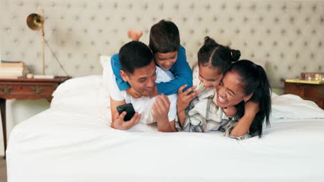 Playing,-parents-and-children-on-bed-with-phone