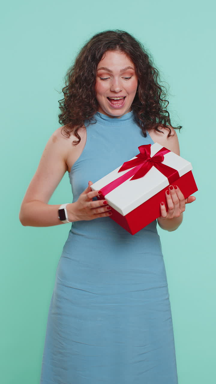 Woman presenting birthday gift box offer wrapped present career bonus celebrating party sale
