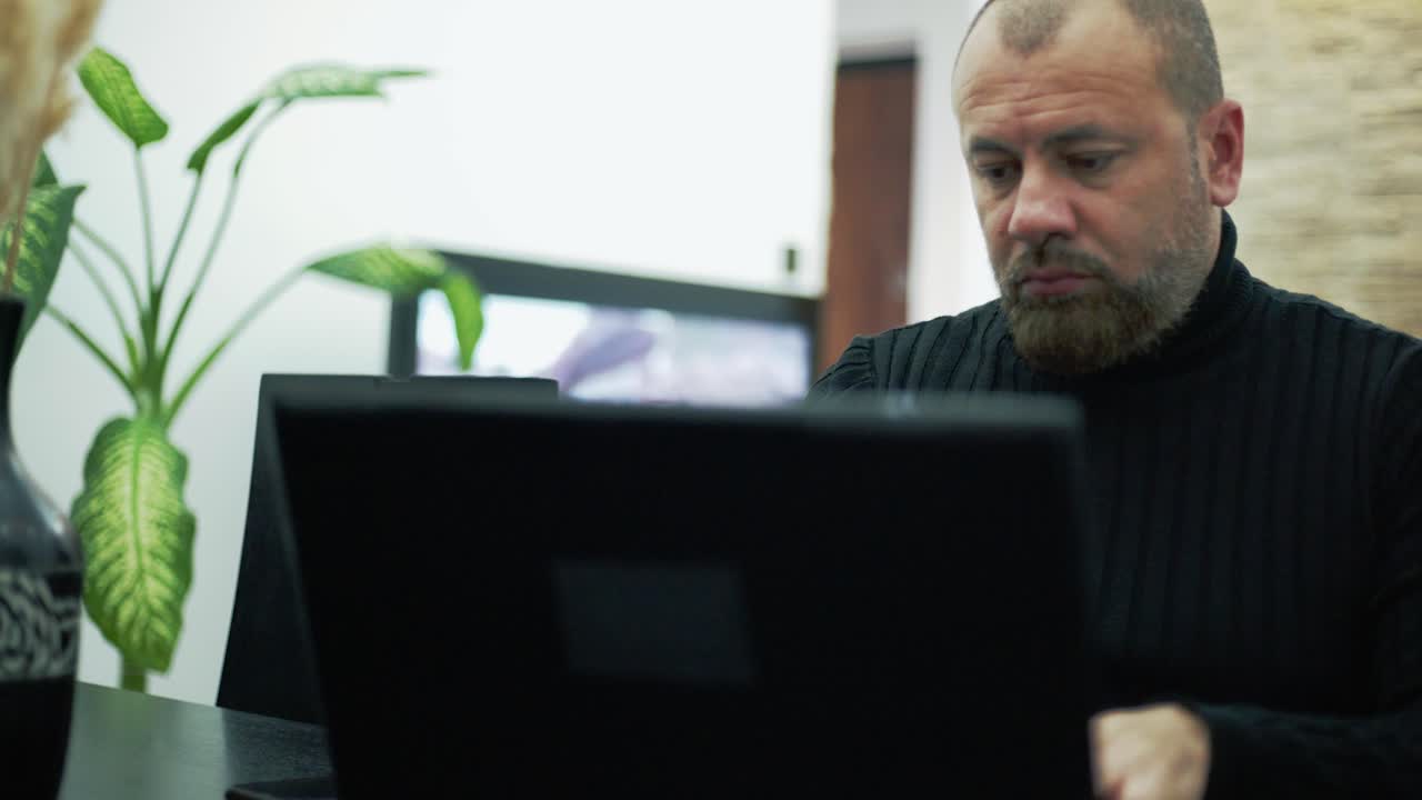 A worried man on the phone in the living room