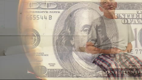 animation of burning dollar banknote over senior caucasian man