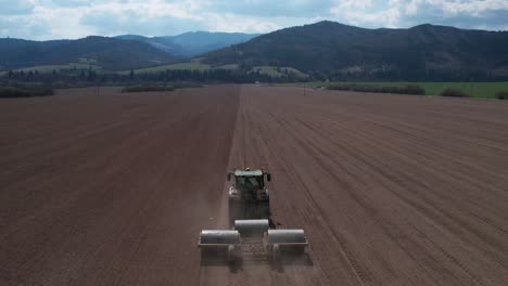 food industry concept, aerial view of tractor preparing farming land for another seeding season