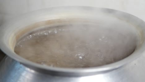 boiling water in a metal pot