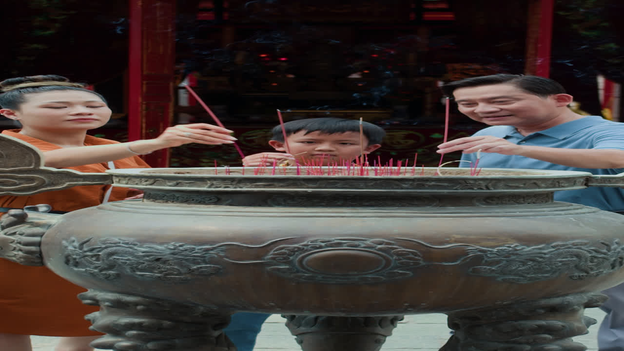 Vertical of Family Praying by Altar Outdoors