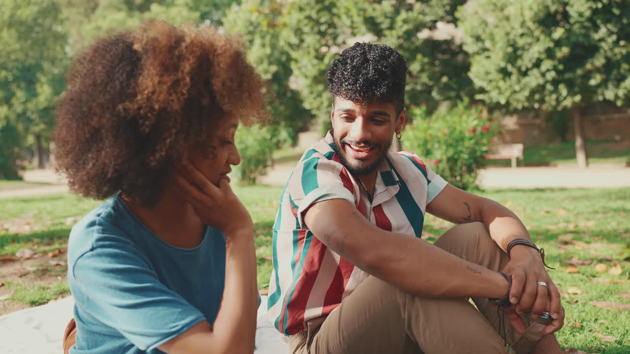 Young Couple Enjoying a Picnic in the Park