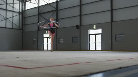 teenage female gymnast performing at sports hall