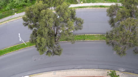 Top-Down-of-Cars-and-Motorcycles-Passing-on-Curved-Road