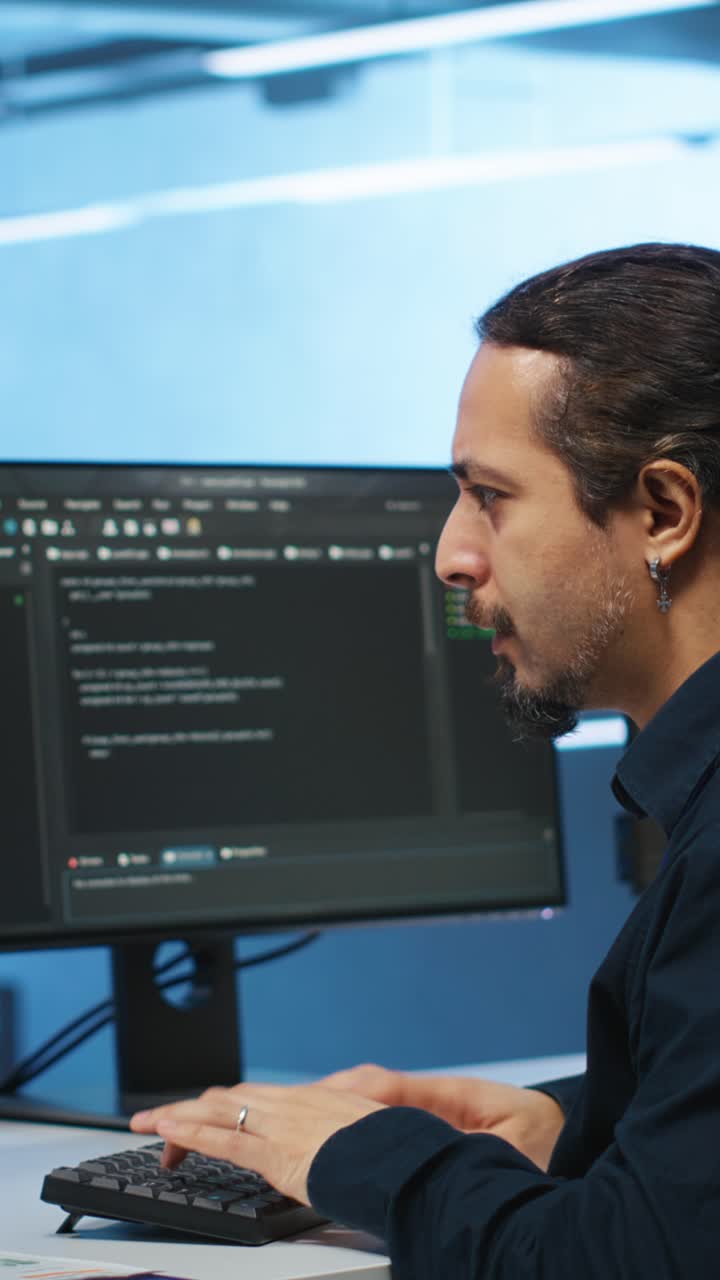 Focused Male Developer Typing Code on Computer in Office