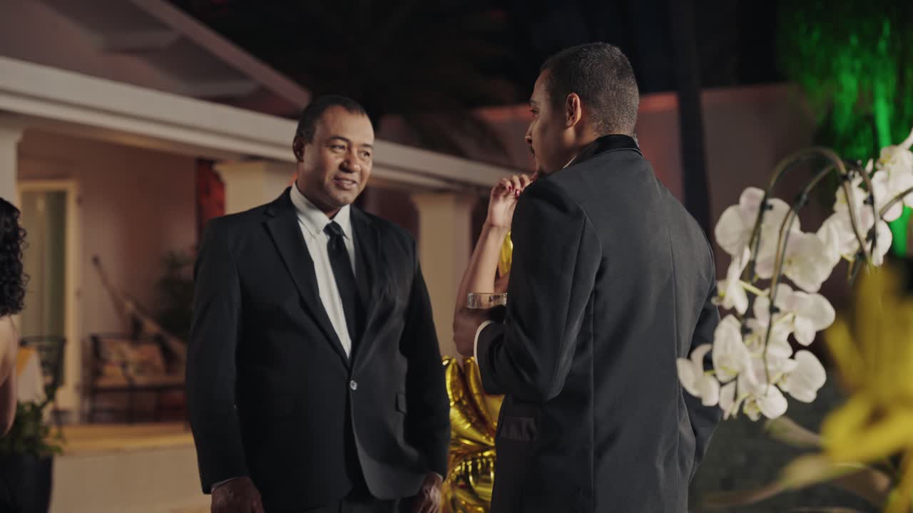 People socializing at an elegant outdoor night event