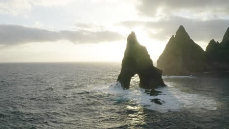 aerial shot over sao lourenco in madeira during sunset with sunrays peaking through