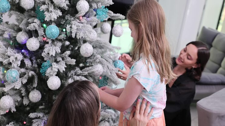 Family decorating a festive Christmas tree