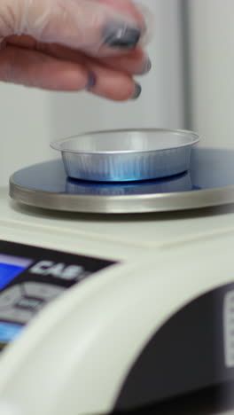 weighing pet food sample in a laboratory setting