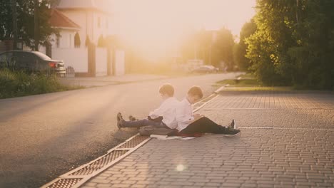 boy-shakes-hand-sitting-near-kid-writing-in-copybook