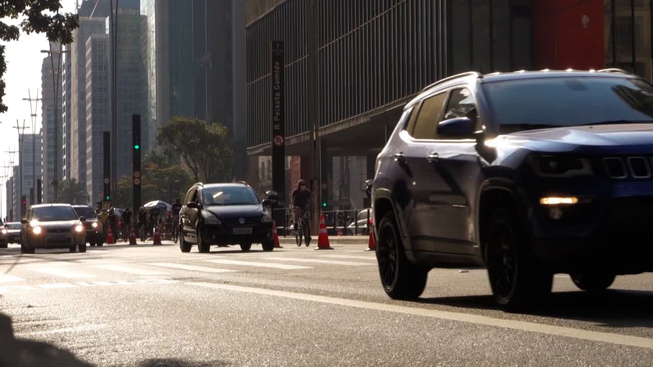 vehicle traffic on Avenida Paulista at dusk. In background it is the MASP, Museum of Art of Sao Paulo
